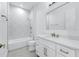 Modern bathroom showcasing white cabinetry, marble countertop, and sleek fixtures at 28960 Gin Ln, Punta Gorda, FL 33982