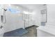 Stylish bathroom featuring a walk-in shower with mosaic tile and a double vanity with bright lighting at 28960 Gin Ln, Punta Gorda, FL 33982