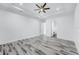 Spacious bedroom with wood-look flooring, a modern ceiling fan, and access to an ensuite bathroom at 28960 Gin Ln, Punta Gorda, FL 33982