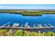 Aerial view of a boat dock, showcasing multiple boats and slips on the water, surrounded by lush greenery at 28960 Gin Ln, Punta Gorda, FL 33982