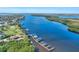 Aerial perspective of a boat dock with multiple slips, boasting waterfront access and lush surroundings at 28960 Gin Ln, Punta Gorda, FL 33982