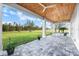 Enjoy the covered patio with paver flooring and views of the spacious backyard at 28960 Gin Ln, Punta Gorda, FL 33982
