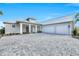 Attractive single-story home featuring an oversized two-car garage and stone paver driveway at 28960 Gin Ln, Punta Gorda, FL 33982
