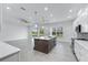 Spacious kitchen featuring a central island, modern pendant lights, and sliding glass doors at 28960 Gin Ln, Punta Gorda, FL 33982