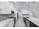 Modern kitchen with stainless steel appliances, an island with a sink, and bright, white cabinets at 28960 Gin Ln, Punta Gorda, FL 33982