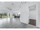 Bright, open-concept living space featuring tile floors, a modern ceiling fan, and large sliding glass doors at 28960 Gin Ln, Punta Gorda, FL 33982