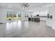 Expansive living room seamlessly transitions into a chef's kitchen with an island and patio access at 28960 Gin Ln, Punta Gorda, FL 33982