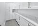 Well-organized pantry featuring ample white cabinets and marbled countertops, offering plenty of storage at 28960 Gin Ln, Punta Gorda, FL 33982