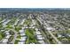 Expansive aerial view of a residential neighborhood showcasing well-maintained homes and lush landscaping near the water at 3278 Village Green Dr # 1024, Sarasota, FL 34239