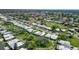 Beautiful neighborhood setting featuring mature trees and lush green grass at 3278 Village Green Dr # 1024, Sarasota, FL 34239