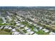 Expansive aerial view of a residential neighborhood showcasing well-maintained homes and lush landscaping near the water at 3278 Village Green Dr # 1024, Sarasota, FL 34239