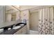 Bathroom featuring neutral tiled shower-tub, black granite countertop, and storage at 3278 Village Green Dr # 1024, Sarasota, FL 34239