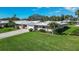 Charming single-story home featuring an attached garage, mature landscaping, and a well-manicured lawn at 3278 Village Green Dr # 1024, Sarasota, FL 34239