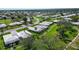 Lovely single-story home with beautiful green lawn, mature trees, and a well-maintained exterior in a quiet community at 3278 Village Green Dr # 1024, Sarasota, FL 34239
