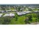 Quaint single-story residence boasts a beautifully manicured lawn, mature landscaping, and a peaceful setting near a golf course at 3278 Village Green Dr # 1024, Sarasota, FL 34239