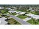 Beautiful single-story home featuring a lush green lawn, palm trees, and a welcoming driveway in a serene neighborhood at 3278 Village Green Dr # 1024, Sarasota, FL 34239