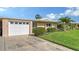 Inviting home features an attached garage, and manicured landscaping, and ample parking at 3278 Village Green Dr # 1024, Sarasota, FL 34239