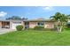 Inviting one-story home features an attached garage, manicured landscaping, and an inviting entrance at 3278 Village Green Dr # 1024, Sarasota, FL 34239