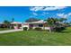 Charming single-story home boasts lush green lawn, attached garage and mature landscaping at 3278 Village Green Dr # 1024, Sarasota, FL 34239