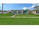 A charming house with a well-maintained lawn and mature landscaping, showcasing its curb appeal at 3278 Village Green Dr # 1024, Sarasota, FL 34239
