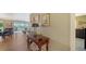 Inviting hallway with wood floors, elegant console table, and artwork, leading to the living area at 3278 Village Green Dr # 1024, Sarasota, FL 34239