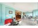 Open-concept living room with neutral tones, terrazzo flooring, and seamless access to adjacent rooms at 3278 Village Green Dr # 1024, Sarasota, FL 34239