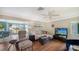 Cozy living room with a comfortable sectional sofa and views of the outdoors at 3278 Village Green Dr # 1024, Sarasota, FL 34239