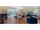 Bright living room features wood floors, comfortable seating, and access to the outdoor patio at 3278 Village Green Dr # 1024, Sarasota, FL 34239