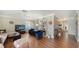 Bright living room featuring a large bookcase, wood floors, and comfortable seating at 3278 Village Green Dr # 1024, Sarasota, FL 34239
