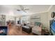 Open-concept living room with wood floors, comfortable seating, and access to the dining area at 3278 Village Green Dr # 1024, Sarasota, FL 34239