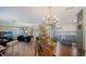 Combined living and dining areas with wood floors and lots of natural light at 3278 Village Green Dr # 1024, Sarasota, FL 34239