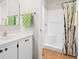 A bright bathroom with a tile shower and white cabinets at 3300 Loveland Blvd # 3203, Punta Gorda, FL 33980