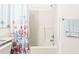 Clean bathroom showcasing a shower-tub combo with seashell shower curtain and grab bar at 3300 Loveland Blvd # 3203, Punta Gorda, FL 33980