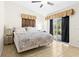 A bright bedroom with sliding glass doors to the lanai and tile flooring throughout at 3300 Loveland Blvd # 3203, Punta Gorda, FL 33980