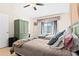 Cozy bedroom featuring two twin beds, a ceiling fan, and natural light from the window at 3300 Loveland Blvd # 3203, Punta Gorda, FL 33980