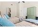 Bright bedroom with two twin beds, open closet, green storage unit, and ceiling fan at 3300 Loveland Blvd # 3203, Punta Gorda, FL 33980