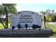 An entrance sign featuring landscaping and stone masonry work marks the neighborhood at 3300 Loveland Blvd # 3203, Punta Gorda, FL 33980