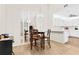 The dining area features a chandelier, mirrored wall, a table with four chairs and a view into the kitchen at 3300 Loveland Blvd # 3203, Punta Gorda, FL 33980