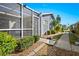 Home exterior displaying landscaping, siding, a sidewalk, and a screen enclosed patio area for outdoor relaxation at 3300 Loveland Blvd # 3203, Punta Gorda, FL 33980
