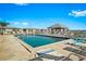 This community pool area features lounge chairs, a pavilion, and nearby residential buildings at 3300 Loveland Blvd # 3203, Punta Gorda, FL 33980