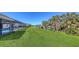 Expansive backyard view with golf course and pond views from behind the screened patio at 3837 Torrey Pines Blvd, Sarasota, FL 34238