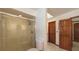 Bright bathroom features a glass-enclosed shower with a shower head and a skylight for natural light at 3837 Torrey Pines Blvd, Sarasota, FL 34238