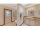 Bright bathroom with marble floors, white cabinets, and access to the outside at 3837 Torrey Pines Blvd, Sarasota, FL 34238