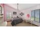 Bedroom with a gray bed, pink walls, and a vanity with natural lighting at 3837 Torrey Pines Blvd, Sarasota, FL 34238