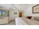 Cozy bedroom features a ceiling fan, dresser, and comfortable bed at 3837 Torrey Pines Blvd, Sarasota, FL 34238