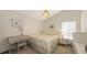 Cozy bedroom boasts neutral tones, complemented by a comfortable bed and a charming desk area at 3837 Torrey Pines Blvd, Sarasota, FL 34238