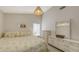 Inviting bedroom with wicker lamp, soft lighting, and ample dresser storage at 3837 Torrey Pines Blvd, Sarasota, FL 34238
