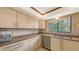 Bright kitchen features granite counters, stainless steel appliances, and a double sink beneath a window at 3837 Torrey Pines Blvd, Sarasota, FL 34238