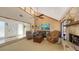 Open living room with stone fireplace, vaulted ceilings, and large windows letting in plenty of natural light at 3837 Torrey Pines Blvd, Sarasota, FL 34238