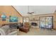 Inviting living room with a stone fireplace, vaulted ceiling, and views of the pool at 3837 Torrey Pines Blvd, Sarasota, FL 34238